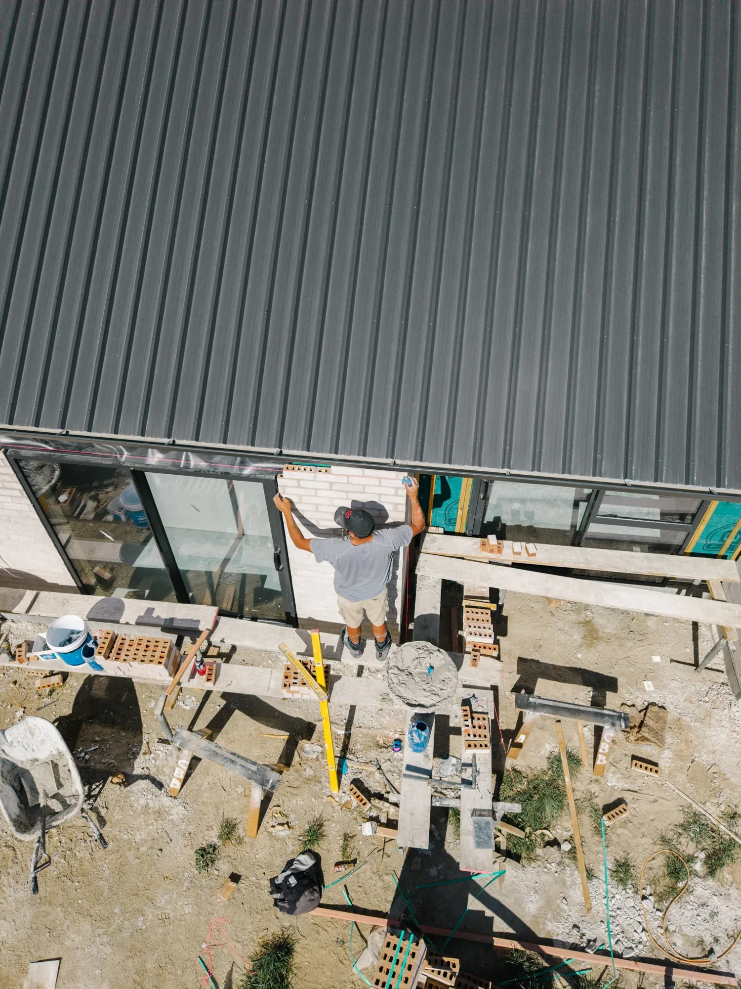 Drone view looking down on the crew working beside the house