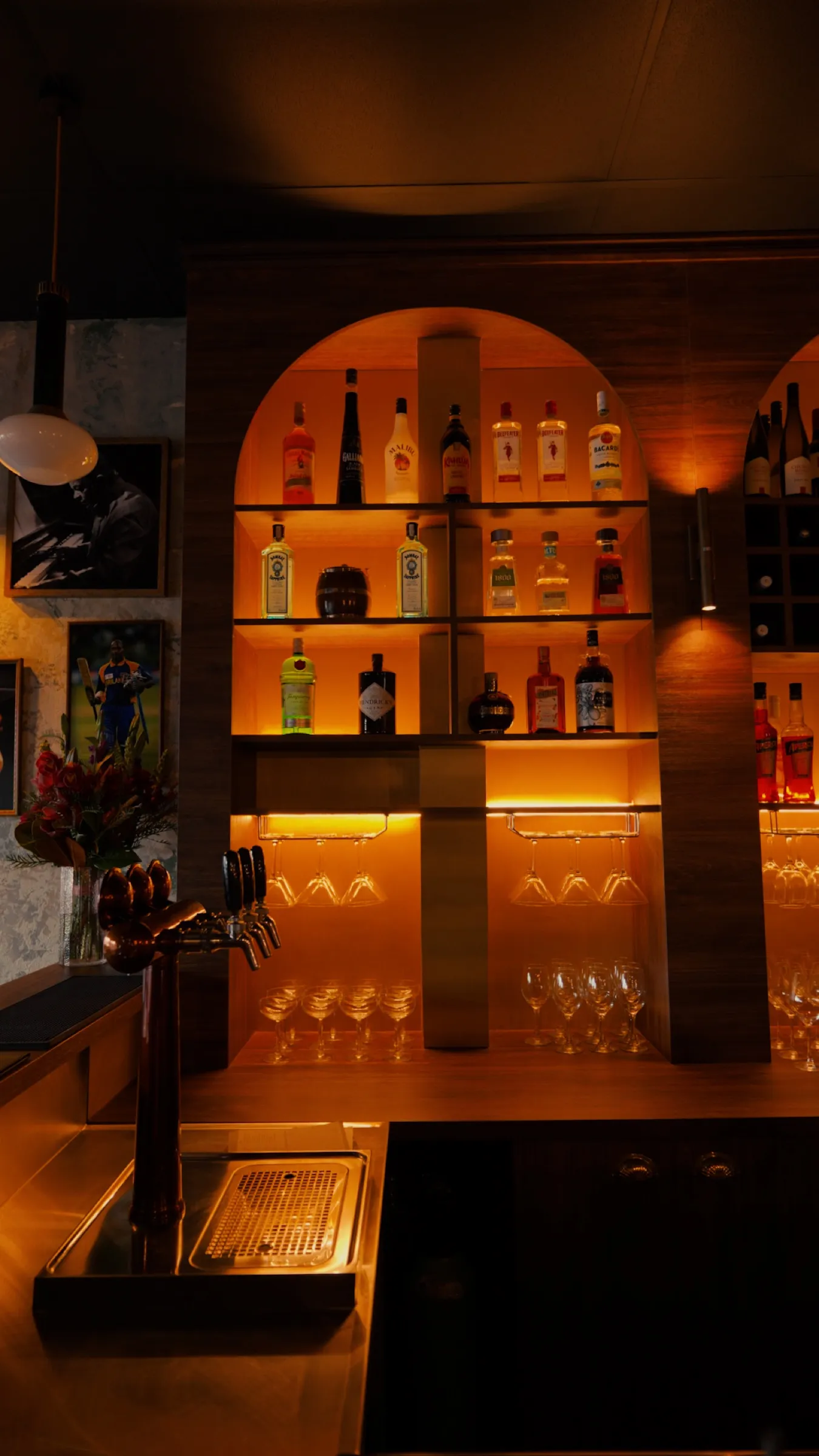 The arched back bar lit in warm orange
