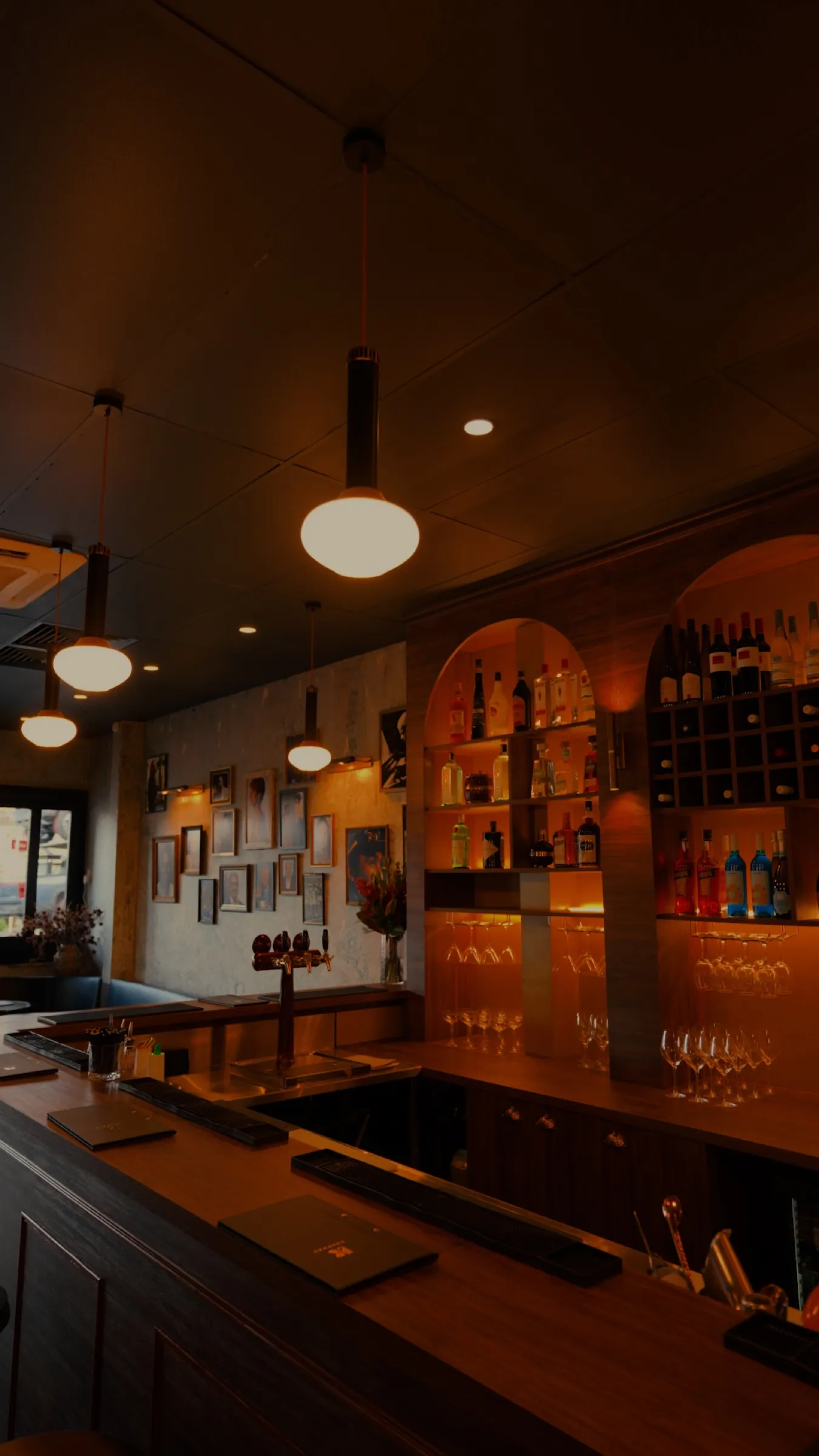 The dining room and bar under pendant lights