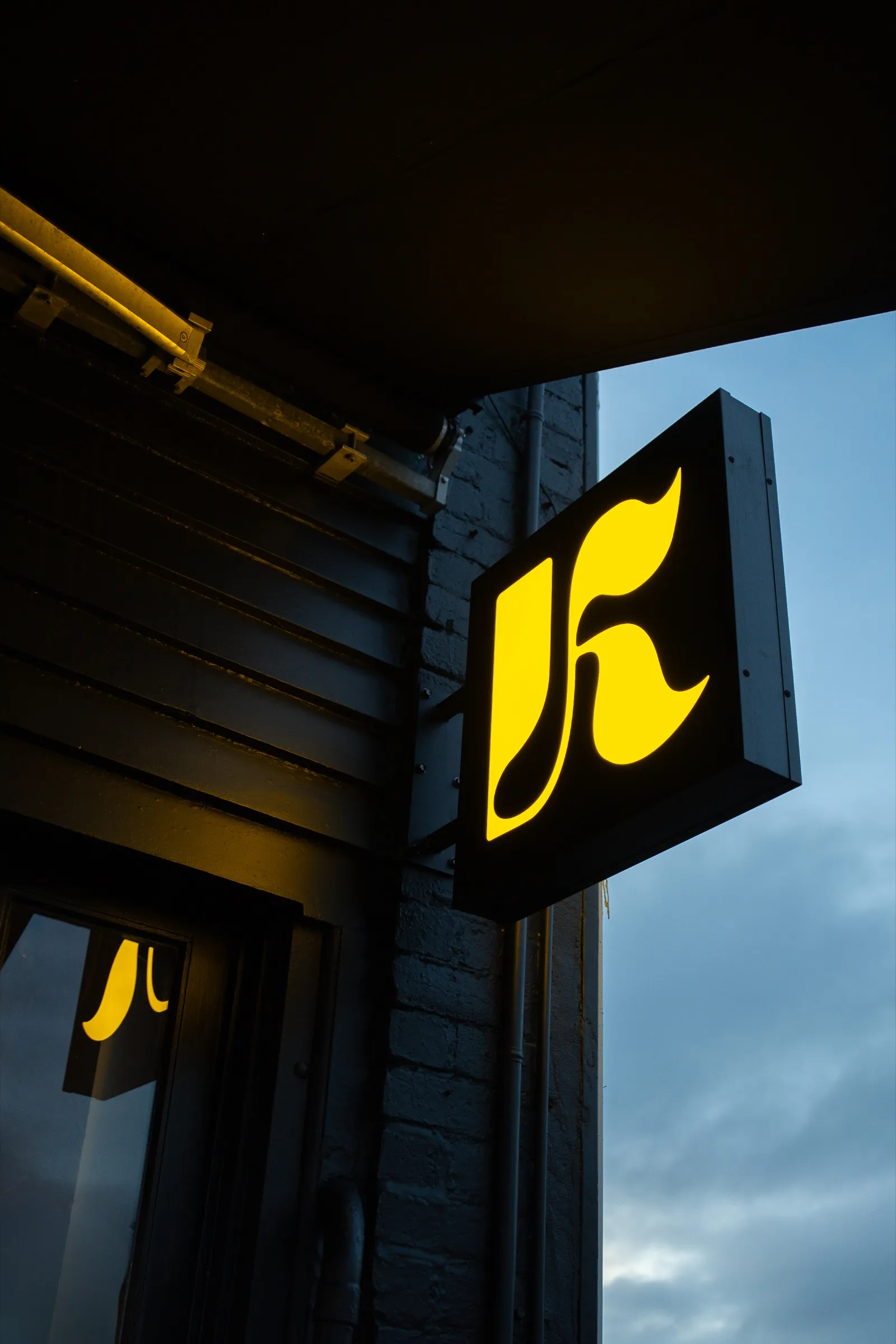 The gold K logo lightbox outside the venue