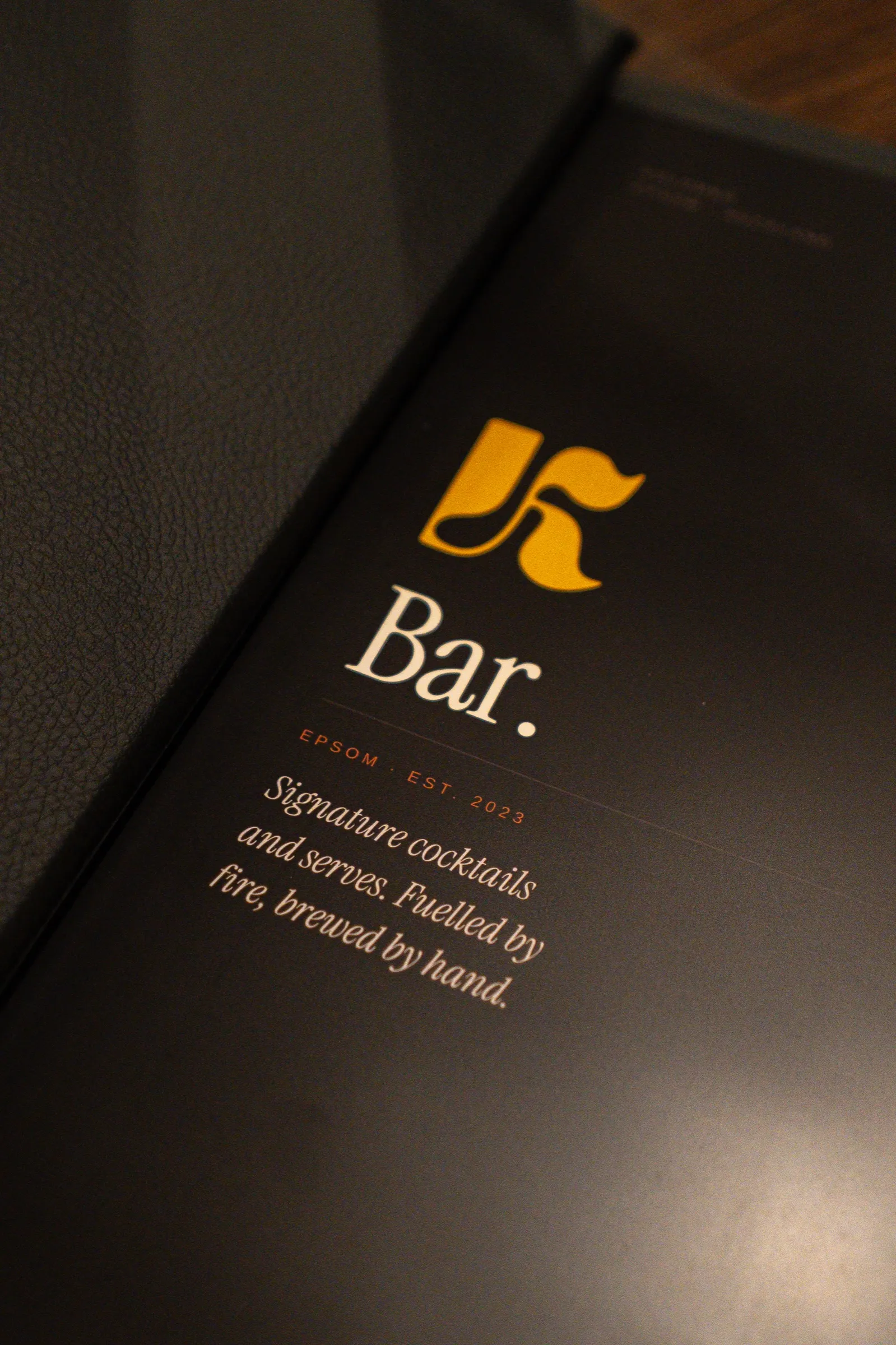 The Kolombo bar menu with the gold K logo